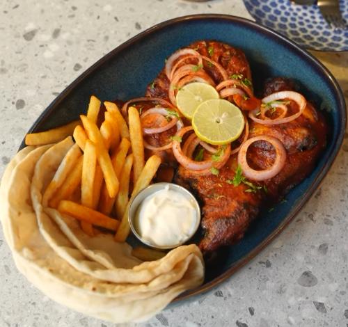 Grilled chicken with fries and flatbread